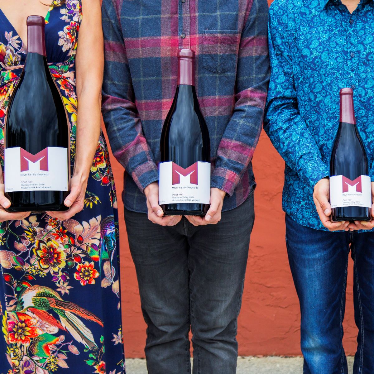 People holding Meyer large format bottles