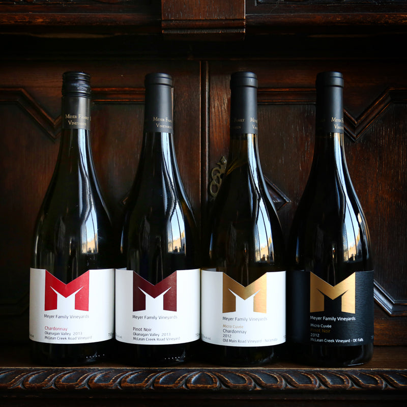 Row of Pinot Noir and Chardonnay bottles