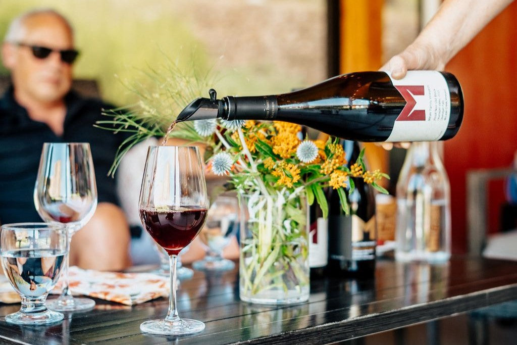 Meyer Pinot Noir being poured into a glass for a tasting